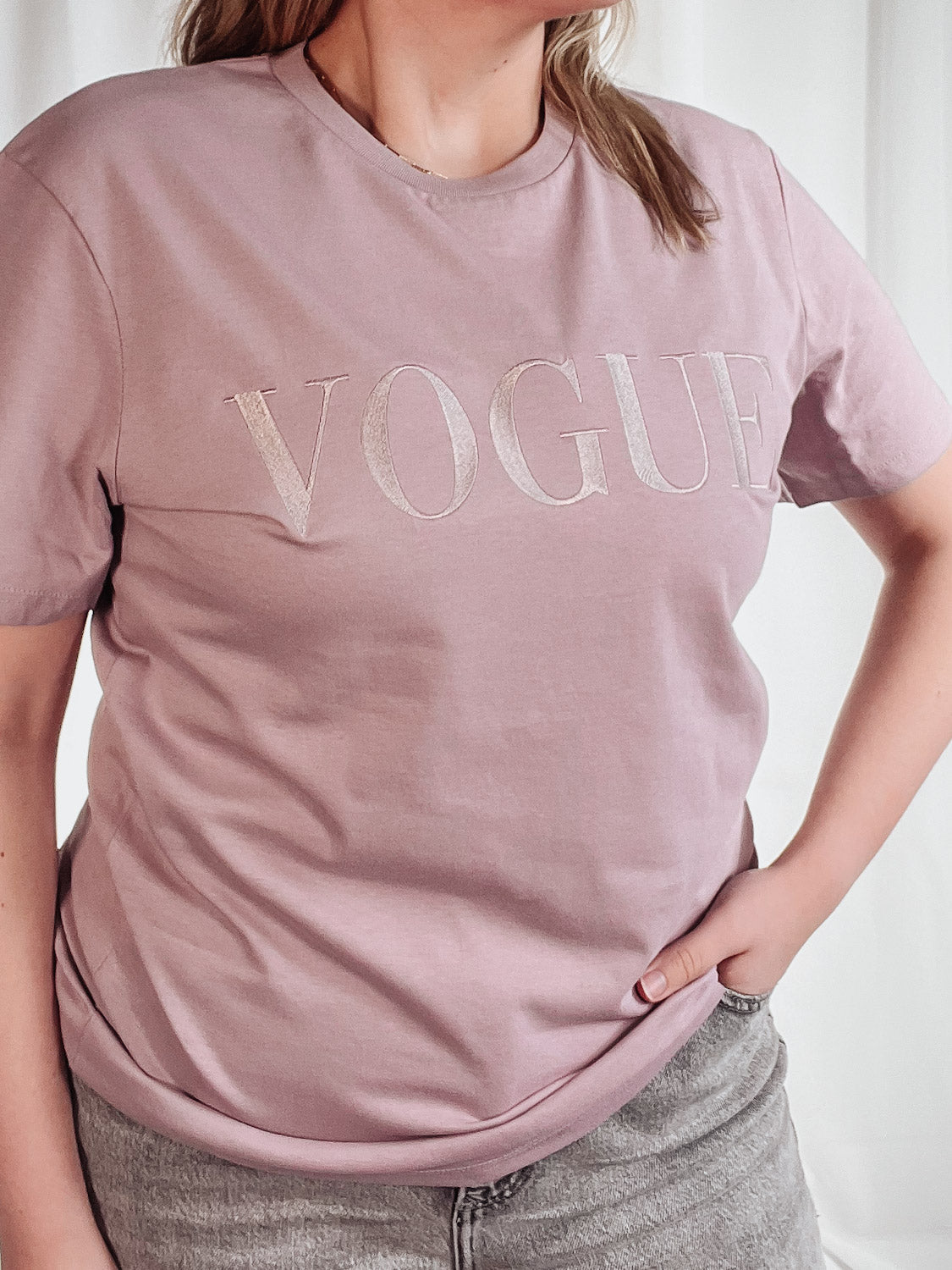 mauve tshirt with in style colour matched embroidered out the purse 